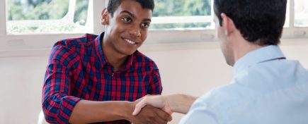 Handshake of african american male apprentice after job interview at office of company